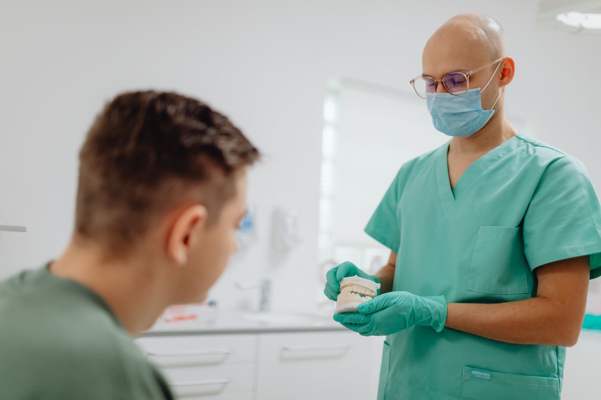 Orthodontist talking with a young patient at a first consultation