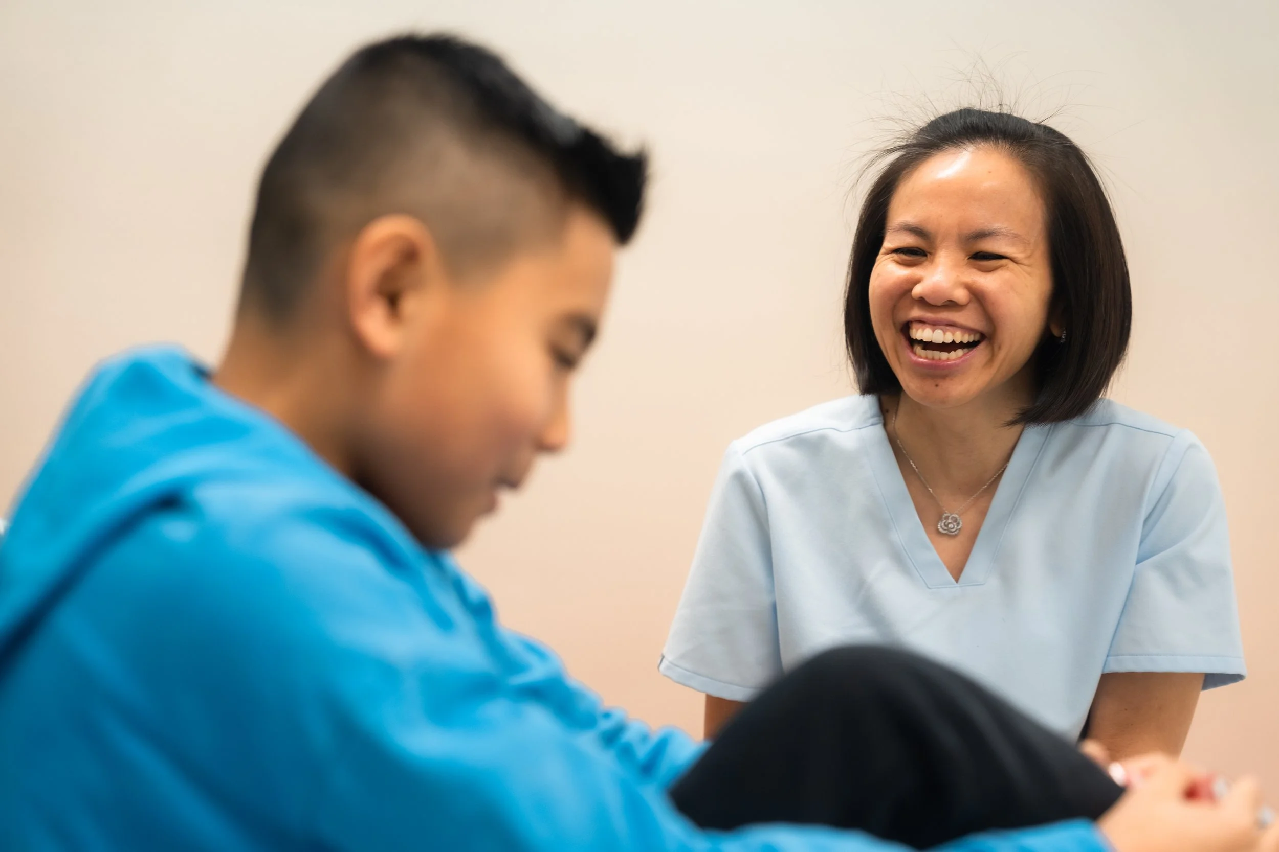 Dr. Shauna Fung laughing with a young patient in the Nexus office