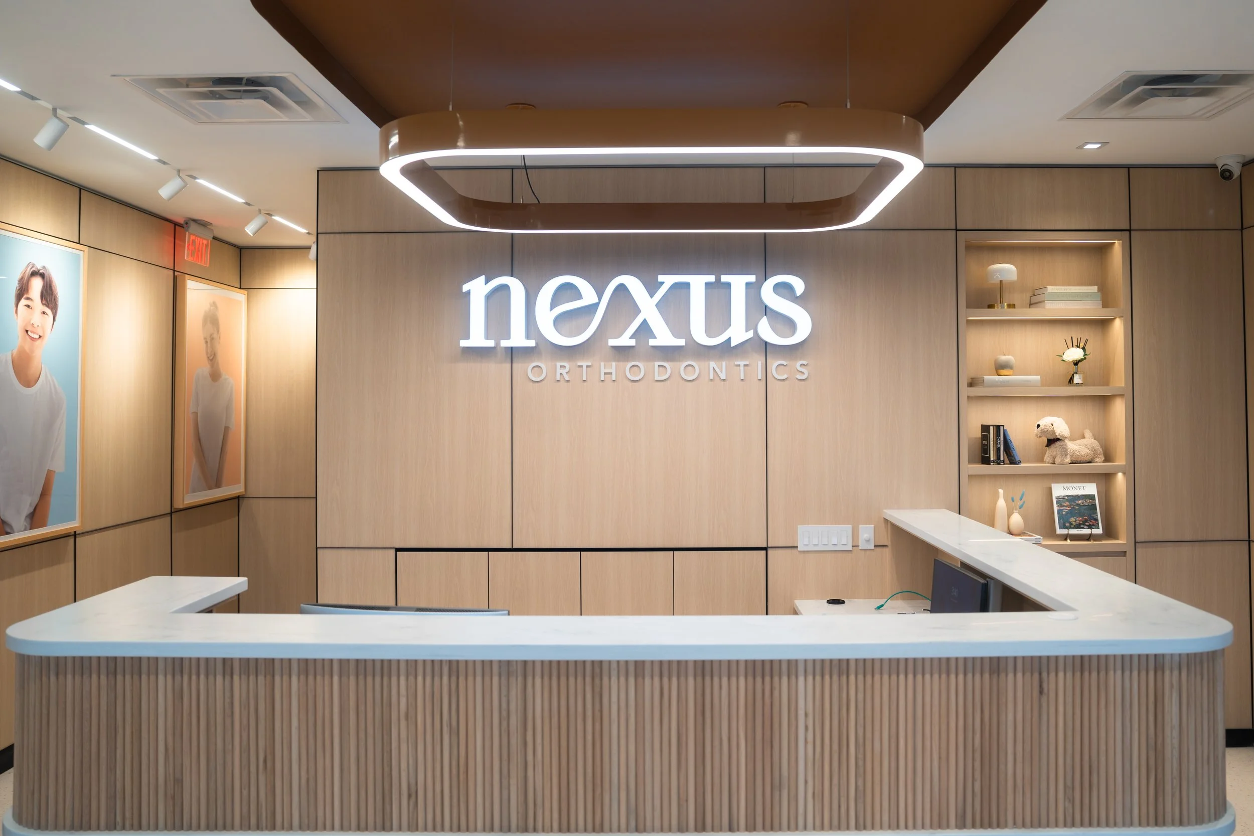 Reception desk with wooden panels and illuminated signage