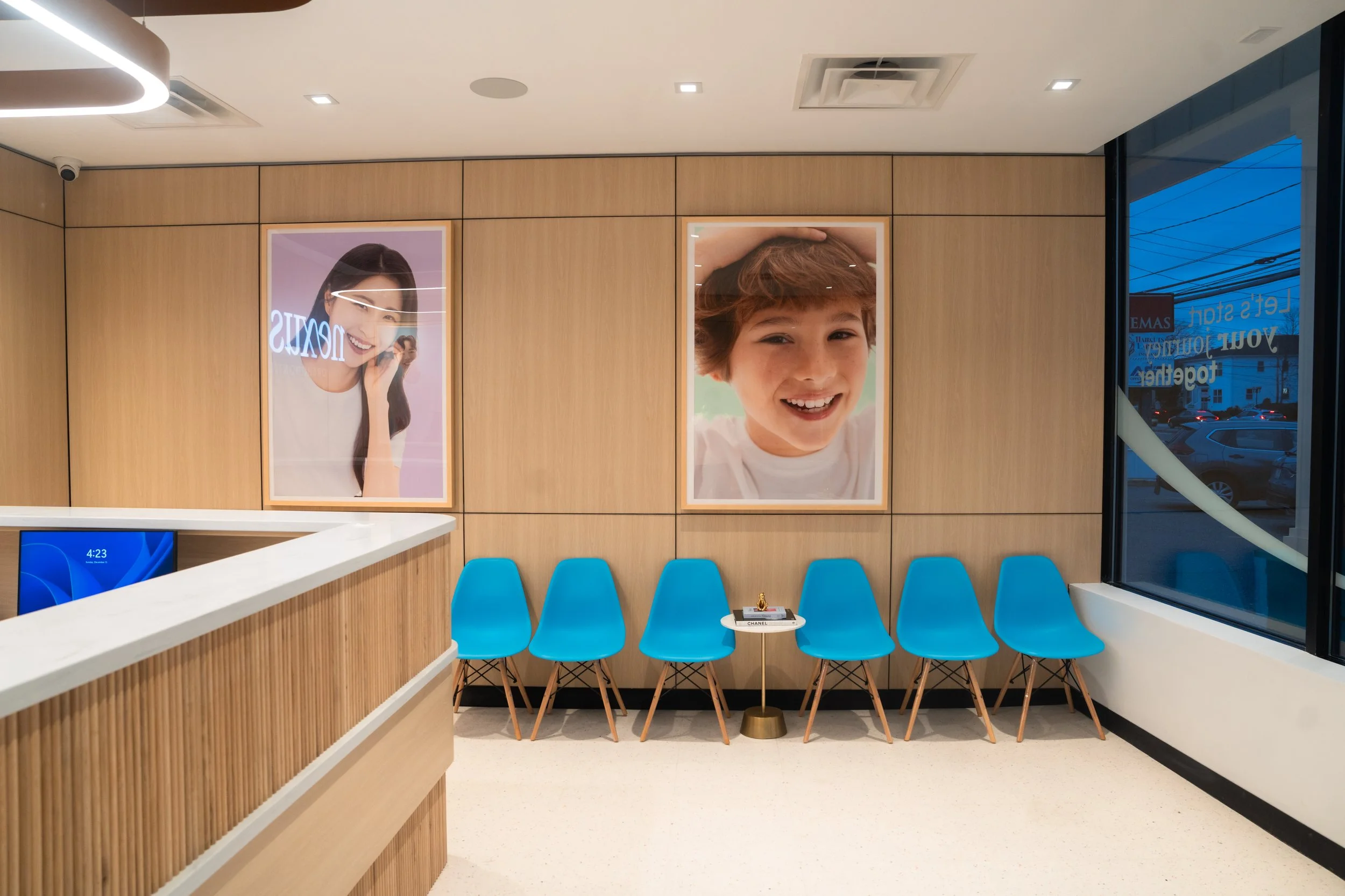 Waiting room with blue chairs and wood paneling