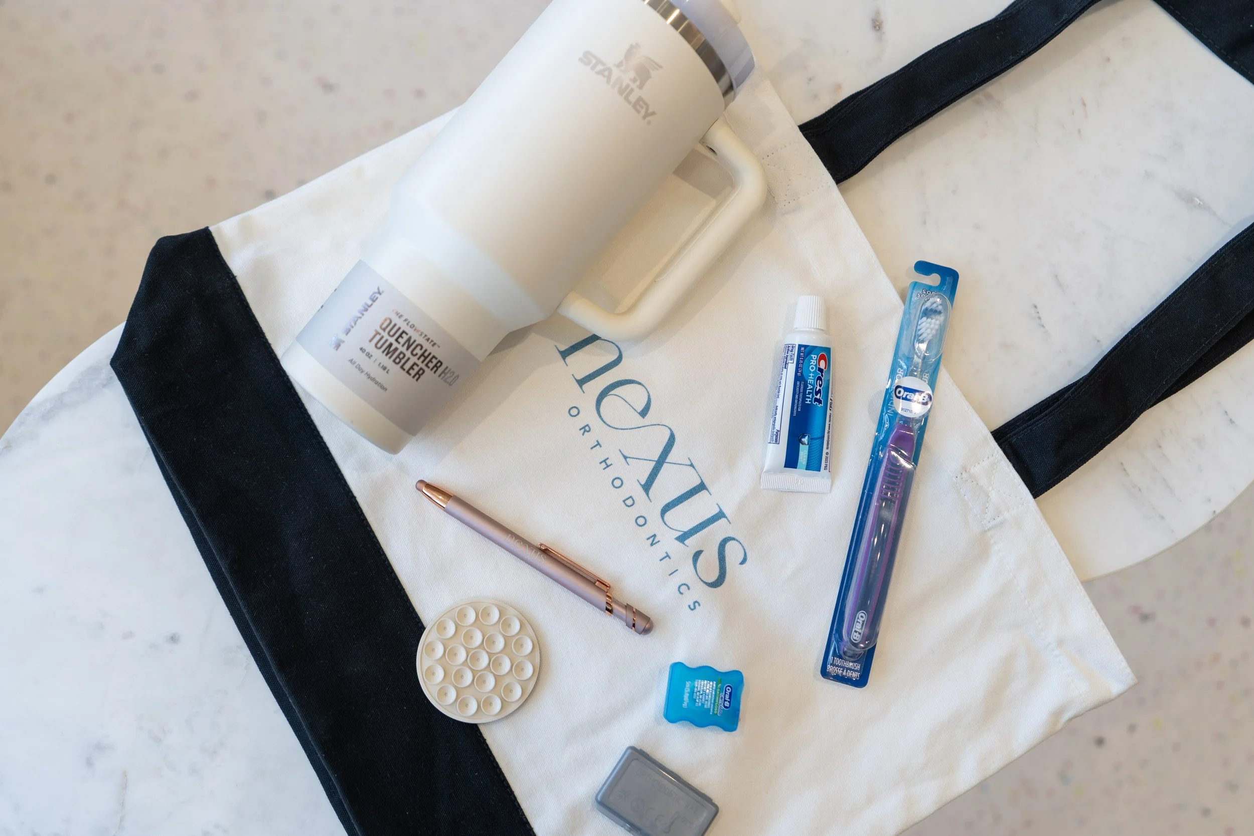 The full Nexus swag bag — tote, mug, sunglasses, pen, and plush toy